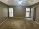 Spacious main bedroom featuring neutral paint, carpet, ceiling fan, and natural light from two windows at 3999 Riverside Pkwy, Decatur, GA 30034