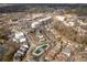 Community aerial view of the neighborhood showcasing the pools, houses, street, and landscape at 360 Chambers St # 301, Woodstock, GA 30188