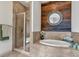 Bathroom boasts a standalone tub with rustic wood accent wall and a glass enclosed shower at 360 Chambers St # 301, Woodstock, GA 30188