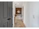 Hallway view of bathroom featuring standalone tub with rustic wood wall at 360 Chambers St # 301, Woodstock, GA 30188