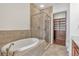 Bathroom features a separate shower and bathtub with a closet room at 360 Chambers St # 301, Woodstock, GA 30188