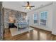 Bedroom features an exposed brick wall, ceiling fan, and natural light from three windows at 360 Chambers St # 301, Woodstock, GA 30188