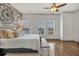 Bedroom features an exposed brick wall, ceiling fan, and natural light from three windows at 360 Chambers St # 301, Woodstock, GA 30188