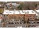 Aerial view of a multi-story building with retail space on the ground floor, a rooftop and ample parking at 360 Chambers St # 301, Woodstock, GA 30188
