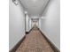 Long hallway with patterned carpeting and recessed lighting at 360 Chambers St # 301, Woodstock, GA 30188