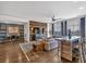Open concept living room featuring a dining table, hardwood floors and rustic wood accent wall at 360 Chambers St # 301, Woodstock, GA 30188