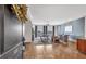Open living room with hardwood floors, natural light, and stylish decor visible from the doorway. Number 301 is on the door at 360 Chambers St # 301, Woodstock, GA 30188