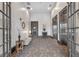 Lobby area with bench seating, wall decor, elevator access and decorative glasswork at 360 Chambers St # 301, Woodstock, GA 30188