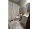 Cozy bathroom with a toilet, functional shelving and a vanity with sink and a bath with shower at 1091 Summer Lake Rd, Lithia Springs, GA 30122