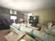 View of the living room showcasing the brick wall and large sectional at 1091 Summer Lake Rd, Lithia Springs, GA 30122