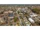 Scenic aerial view of a town showcasing residential and commercial areas, streets, and trees at 16 Ramsey St, Roswell, GA 30075