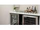 Wet bar with beverage cooler, countertop, and decor elements at 16 Ramsey St, Roswell, GA 30075