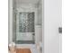 Contemporary bathroom featuring a walk-in shower with a tiled wall and mosaic floor at 16 Ramsey St, Roswell, GA 30075