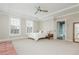 Spacious bedroom featuring tray ceiling, carpet, windows, and tasteful decor at 16 Ramsey St, Roswell, GA 30075