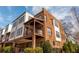 Beautiful townhome featuring brick and siding exterior, covered porch, and lush landscaping at 16 Ramsey St, Roswell, GA 30075
