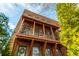 Brick building with wooden beam accents, balconies, and lush greenery at 16 Ramsey St, Roswell, GA 30075