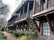 View of the exterior showcasing private balconies, brick facade, and well-maintained landscaping at 16 Ramsey St, Roswell, GA 30075