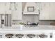 A well-designed kitchen showcases a center island, stainless steel appliances, and a herringbone backsplash at 16 Ramsey St, Roswell, GA 30075