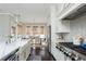 Bright kitchen with farmhouse sink, stainless steel appliances, herringbone backsplash, and dark hardwood floors at 16 Ramsey St, Roswell, GA 30075