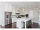 Gourmet kitchen features a marble island, stainless appliances, custom cabinets, and stylish pendant lighting at 16 Ramsey St, Roswell, GA 30075