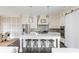Spacious kitchen with island, seating, stainless appliances, and stylish lighting at 16 Ramsey St, Roswell, GA 30075
