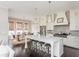 Bright, white kitchen features an island with stool seating, and dining area at 16 Ramsey St, Roswell, GA 30075