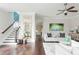 Open-concept living space with staircase, hardwood floors, and stylish decor at 16 Ramsey St, Roswell, GA 30075