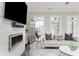 Sun-drenched living room featuring modern fireplace, dark wood floors, and neutral decor at 16 Ramsey St, Roswell, GA 30075