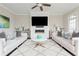 Open living room featuring a modern fireplace, white couches and decor at 16 Ramsey St, Roswell, GA 30075