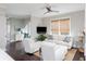Inviting living room with neutral tones, dark wood floors, a ceiling fan, and a wall-mounted television at 16 Ramsey St, Roswell, GA 30075
