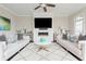 Bright living room with a decorative fireplace, dual sofas, and accent pillows at 16 Ramsey St, Roswell, GA 30075