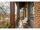 Cozy covered porch features wood decking, stylish seating, and water views at 16 Ramsey St, Roswell, GA 30075