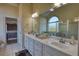 Spacious bathroom featuring double sinks, lots of counter space and a view into the bedroom at 4180 Mount Paran Dr, Social Circle, GA 30025