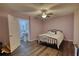 A bedroom with a wrought iron bed, laminated floors, and a private bath at 4180 Mount Paran Dr, Social Circle, GA 30025