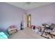 Cozy bedroom with carpet flooring, light purple walls, and an open doorway to another room at 4180 Mount Paran Dr, Social Circle, GA 30025