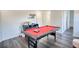 A game room features a red felt pool table, a small gray console, and bright white walls at 4180 Mount Paran Dr, Social Circle, GA 30025