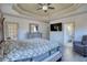 Primary bedroom with a decorative tray ceiling, hardwood floors, and an ensuite bathroom at 4180 Mount Paran Dr, Social Circle, GA 30025