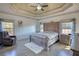 Spacious main bedroom featuring a tray ceiling, hardwood floors, and large windows at 4180 Mount Paran Dr, Social Circle, GA 30025