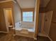 Bright bathroom features a tub with jets and a separate shower at 4667 Derby Loop, Fairburn, GA 30213