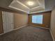 Spacious carpeted bedroom features tray ceiling and a large window at 4667 Derby Loop, Fairburn, GA 30213