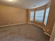 Neutral bedroom with bay windows and wall-to-wall carpet flooring; perfect for relaxation at 4667 Derby Loop, Fairburn, GA 30213