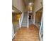 Inviting foyer featuring wood floors transitioning to carpet, staircase, and soaring ceilings at 4667 Derby Loop, Fairburn, GA 30213