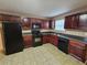 Well-lit kitchen with dark cabinets and black appliances provides the home chef a functional space at 4667 Derby Loop, Fairburn, GA 30213