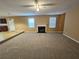 Spacious living room with carpeted flooring and a fireplace, providing comfortable living space at 4667 Derby Loop, Fairburn, GA 30213