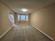 Spacious living room with neutral carpet, large windows, and a cozy atmosphere at 4667 Derby Loop, Fairburn, GA 30213