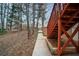 Exterior stairs lead to the homes upper level with tree coverage and side yard at 10440 Cranchester Way, Alpharetta, GA 30022