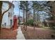 Backyard featuring a wooded area with a walk-out and stairs to an upper deck at 10440 Cranchester Way, Alpharetta, GA 30022