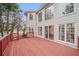 Exterior view of the back of the house featuring a spacious deck and mature trees at 10440 Cranchester Way, Alpharetta, GA 30022