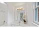 Bright bathroom features a sleek vanity, decorative mirror and shower-tub combo at 10440 Cranchester Way, Alpharetta, GA 30022