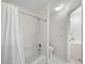 Bathroom featuring white tile, a shower-tub, toilet, and vanity at 10440 Cranchester Way, Alpharetta, GA 30022